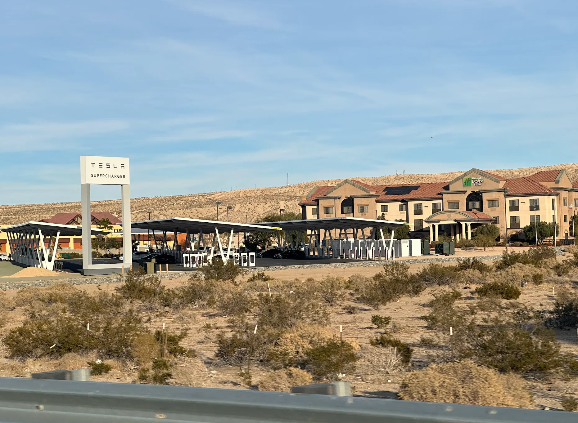 Photo of Tesla supercharger with many stalls. Indicating the Death of the Portable EVSE due to rise of so many chargers.