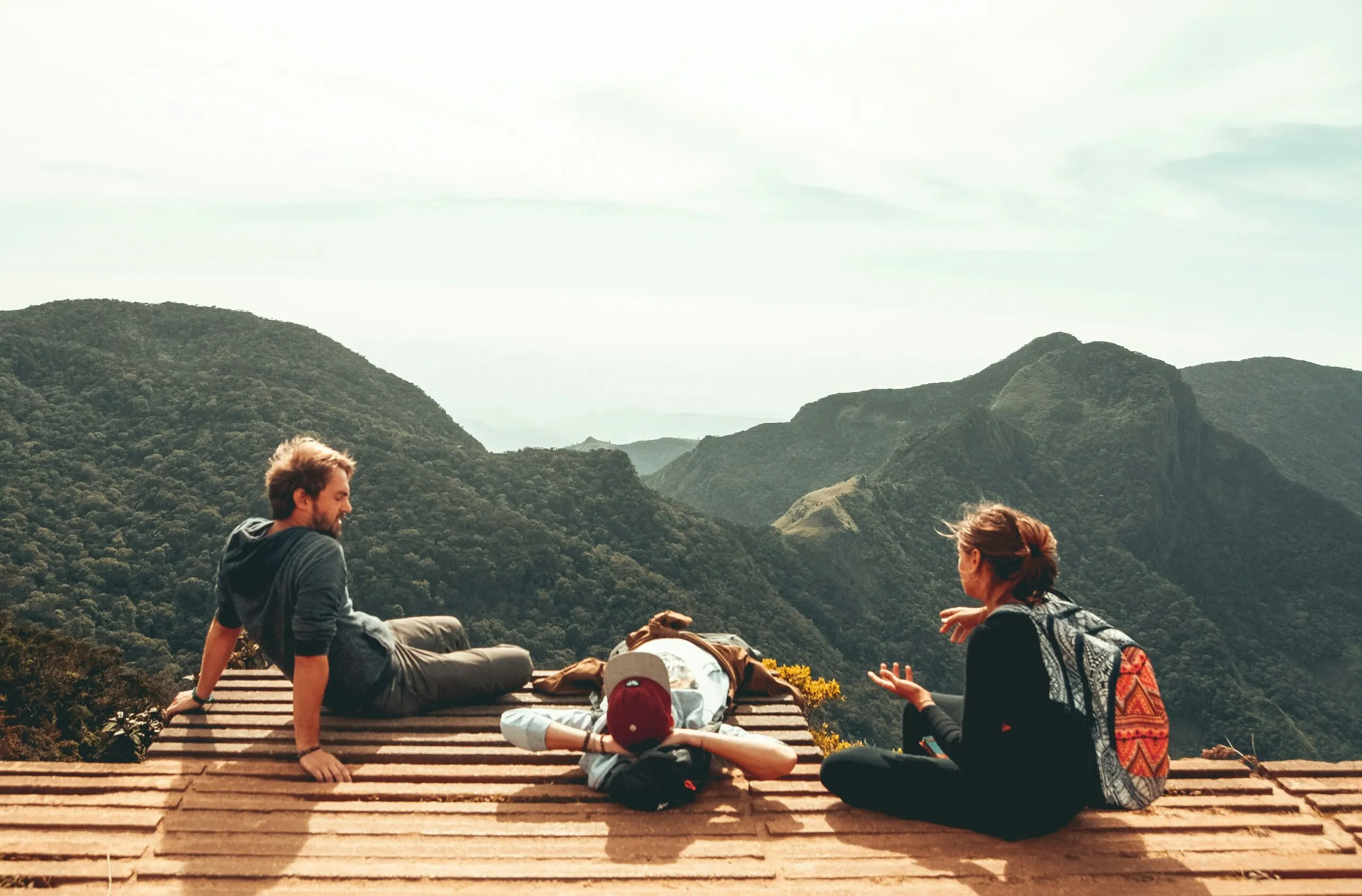 Three travelers in front of a mountain - 50 Questions to Start a Conversation with a Stranger While Traveling Alone