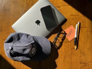 Phone and laptop scattered across table