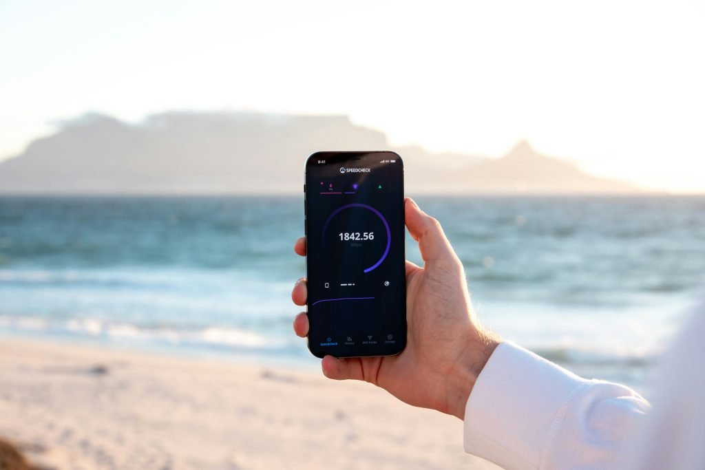 Man using his cellular service on the beach. Is hotel wifi safe?